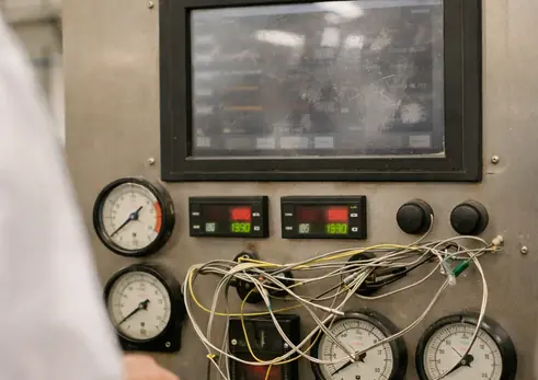 Control panel with gauges and readouts, industrial setting